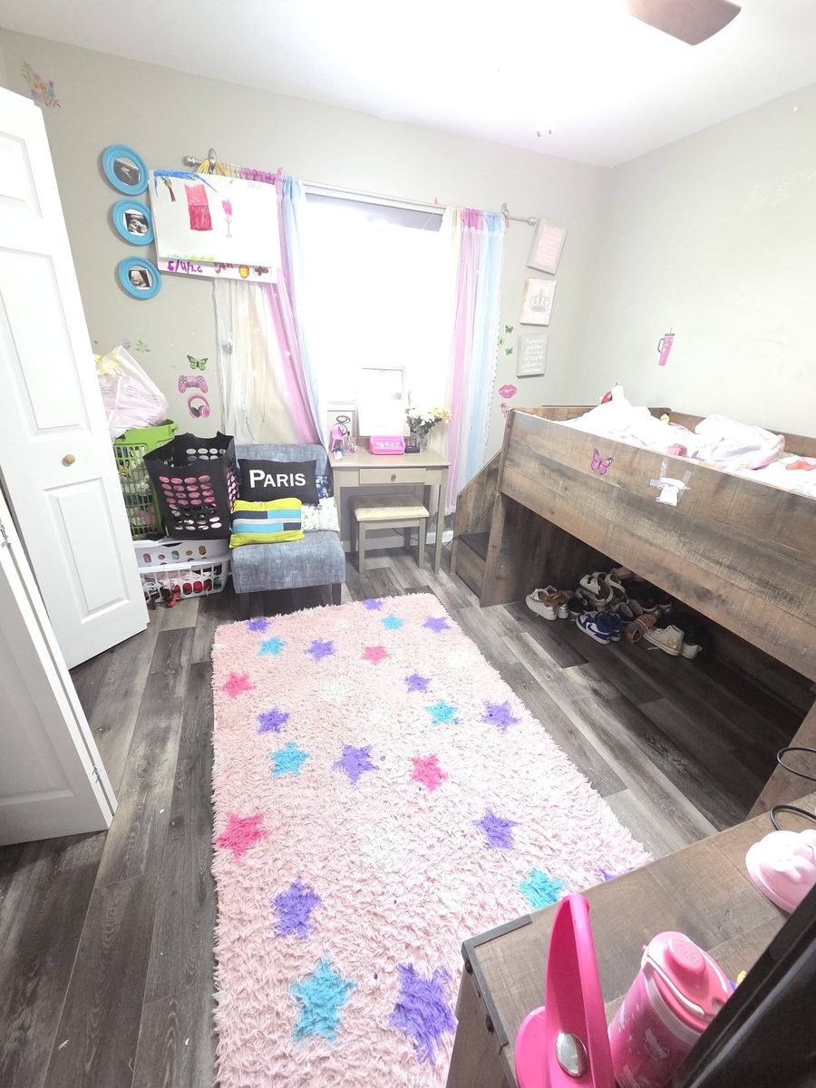 A child's bedroom with the floor cleared and the rug vacuumed after a Home Harmony clean