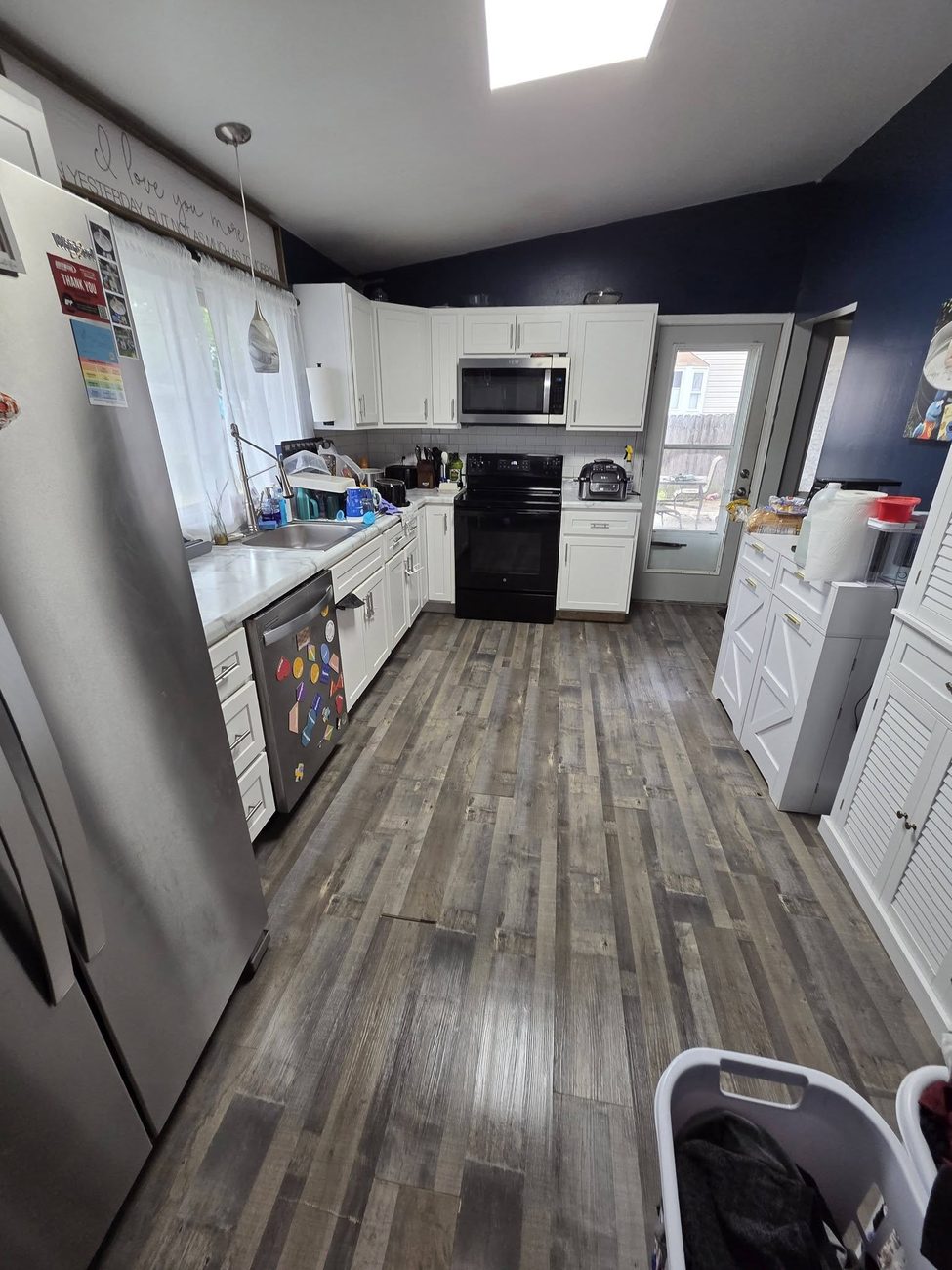 A kitchen with counters cleared and floors mopped