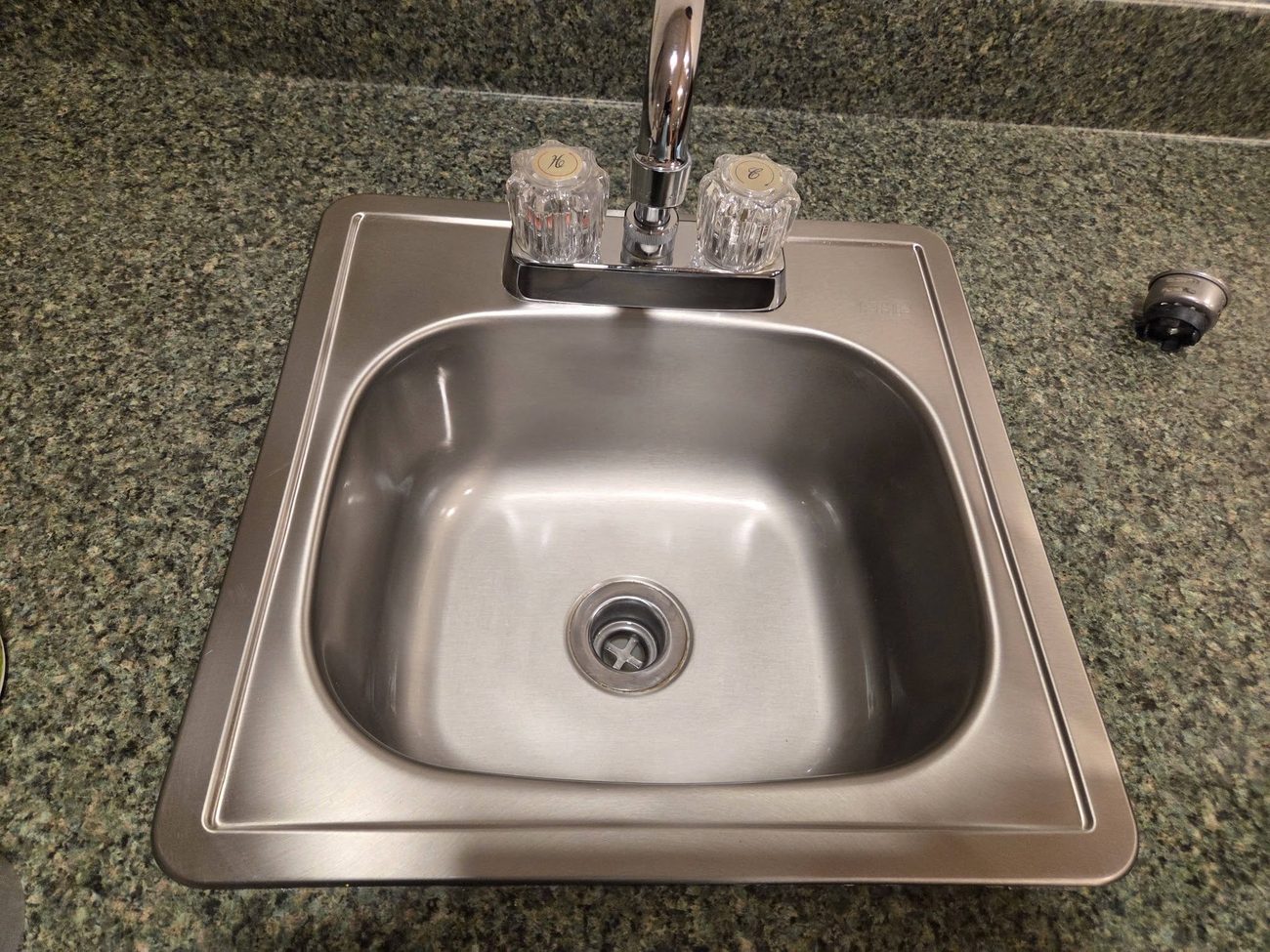 A kitchen sink polished clean